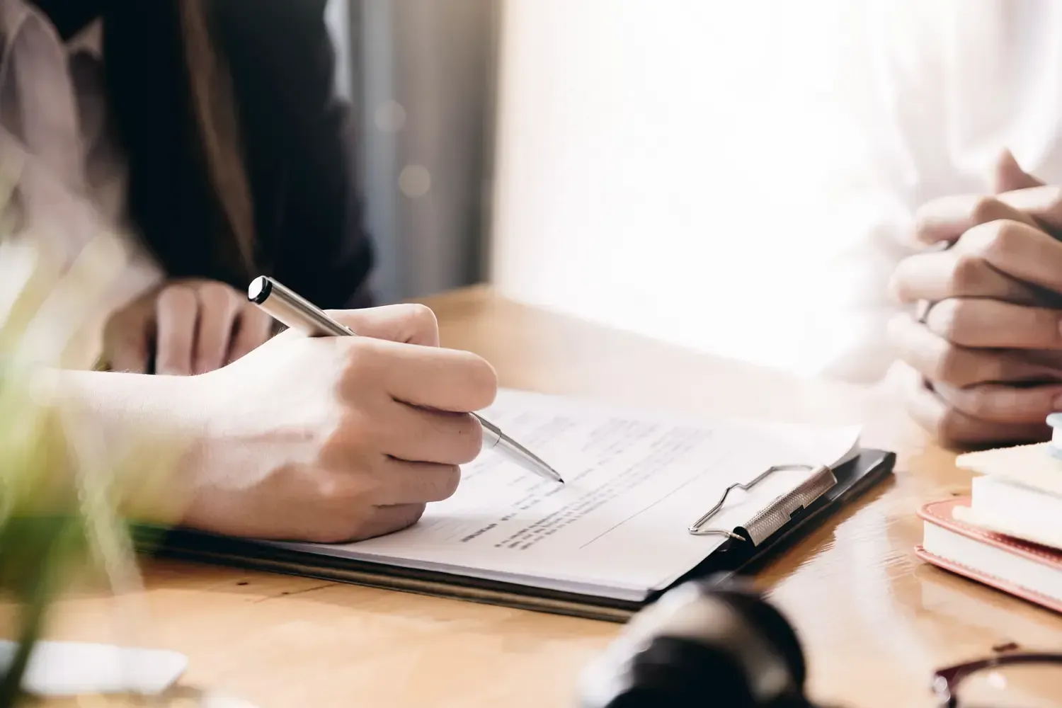 Two people working together over a document