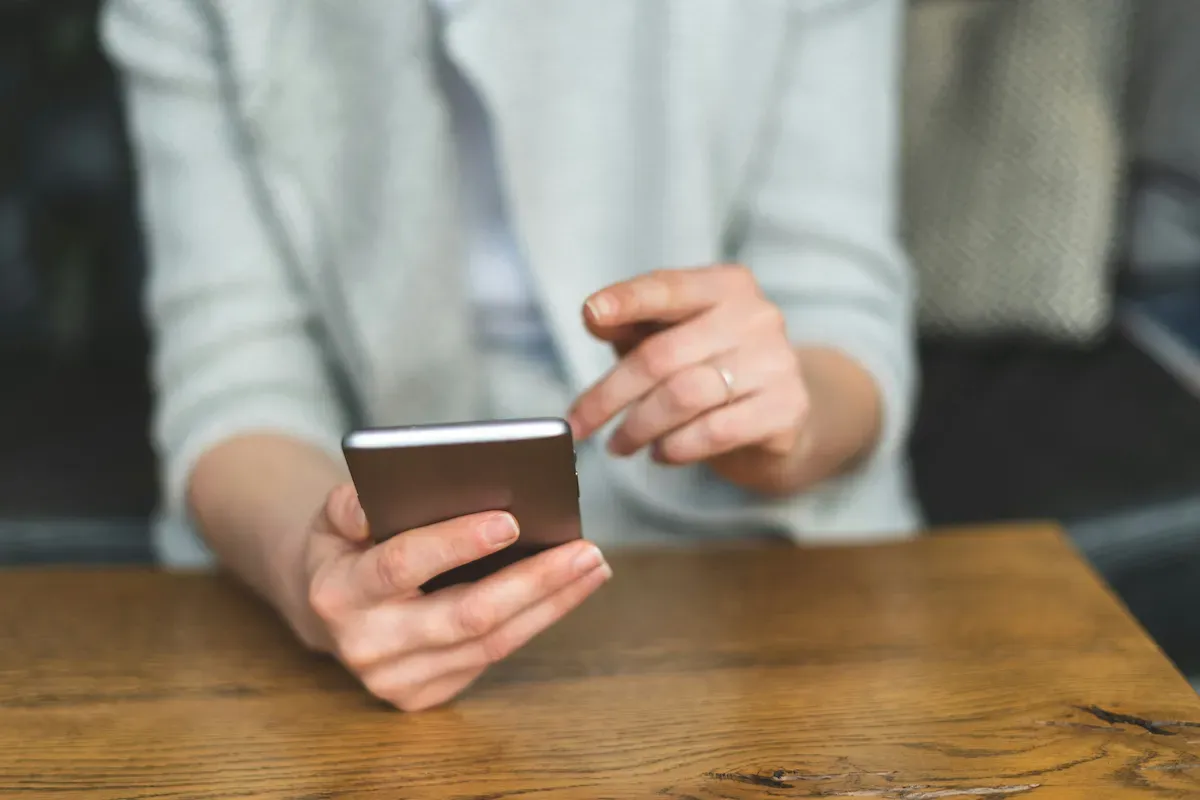 A woman interacting with a cell phone